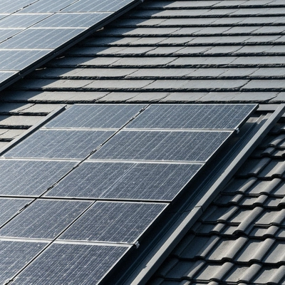 Close-up of modern roofing materials and solar panels, illustrating energy efficiency
